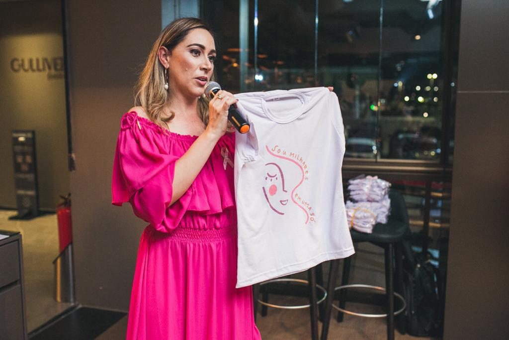Fundadora do Projeto Aghata apresentando a camiseta da campanha em um evento